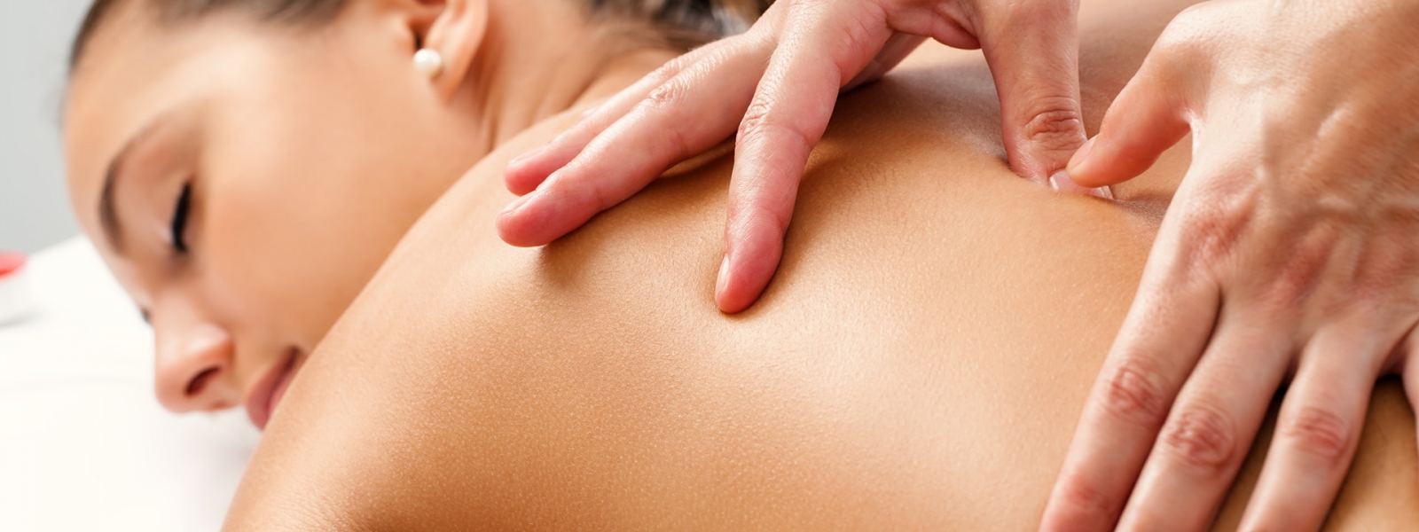 Therapist applying pressure with thumbs on back. Therapist applying pressure with thumbs on back.